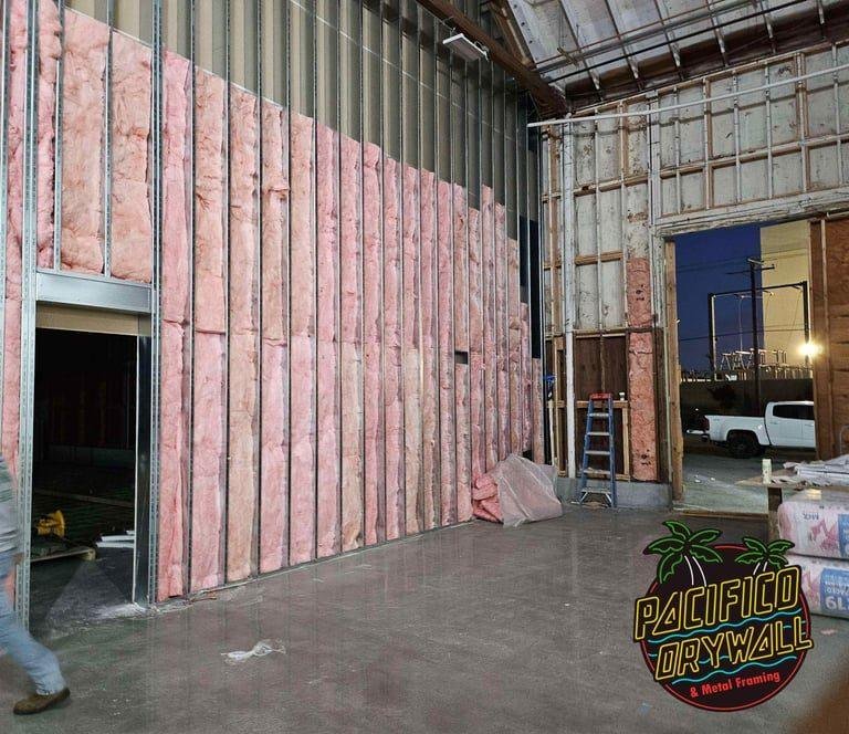 Full-height metal stud framing with insulation